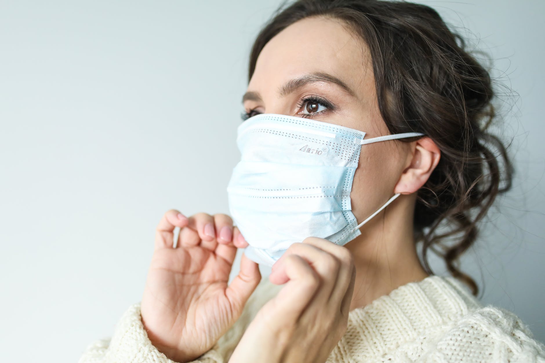 Woman wearing a face mask to prevent the spread of Coronavirus COVID-19