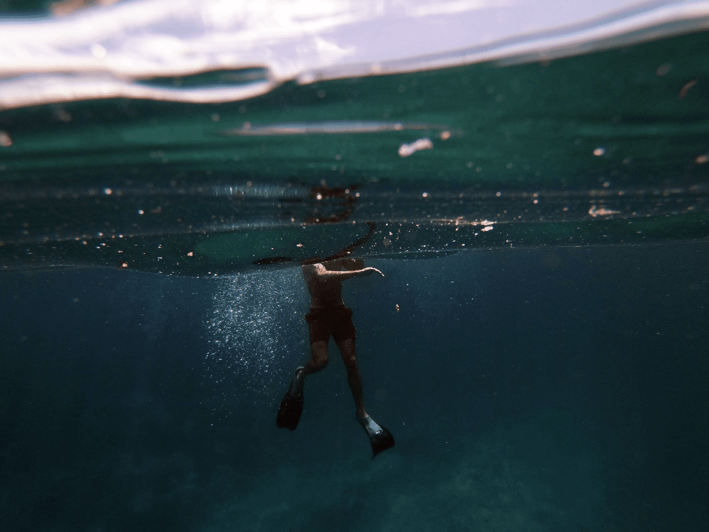 man in black shorts in water