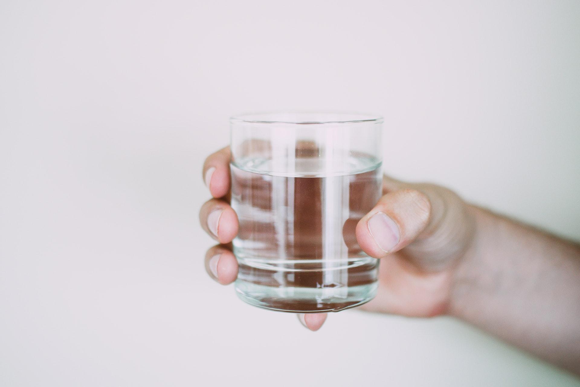 person holding cup of water