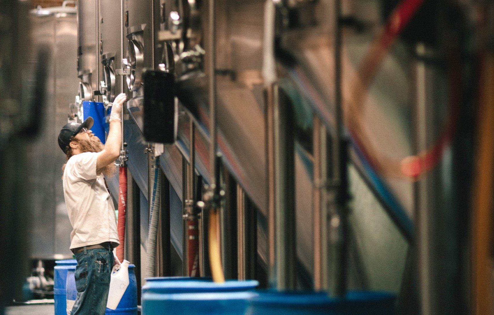 Man inspecting brewery container