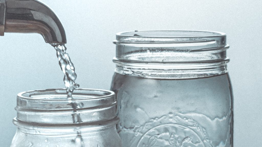 Water pouring into mason jar