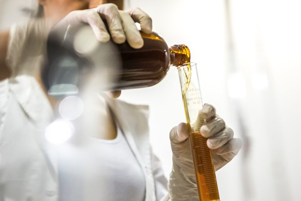 Women manufacturing chemicals in lab