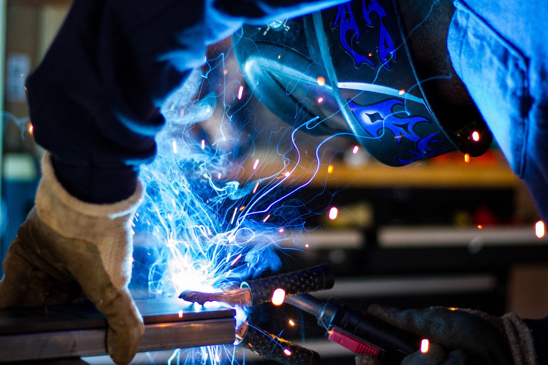 Man welding and finishing a metal surface